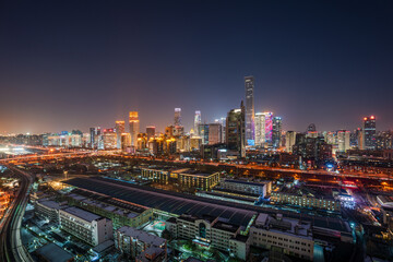 Fototapeta premium After a snowfall in China, Beijing's CBD, including the China Zun building, boasts a vibrant cityscape and a panoramic view of the bustling central business district at night.