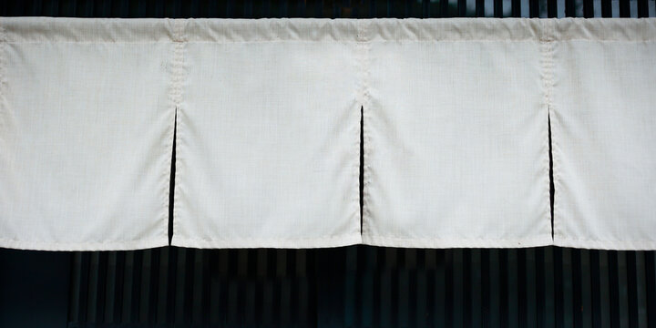 White Japanese noren curtain hanging at traditional shop entrance, Kyoto, Japan