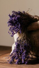 Obraz premium Rustic lavender bundles spill from burlap creating a serene wellness spa aesthetic visual