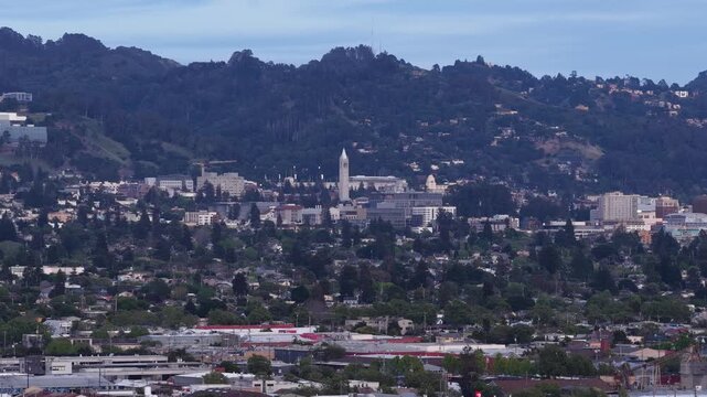 Stunning aerial footage from Albany Bulb capturing the beautiful Berkeley cityscape and the iconic Sather Tower, also known as The Campanile, nestled among the lush green hills of California