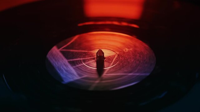Spinning vinyl record with abstract light patterns, vintage music playback motion.