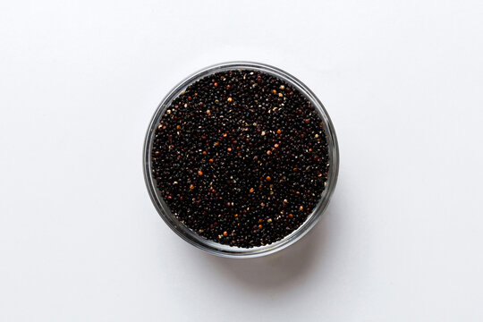 quinoa seeds in bowl on colored background. Healthy kinwa in small bowl. Healthy superfood