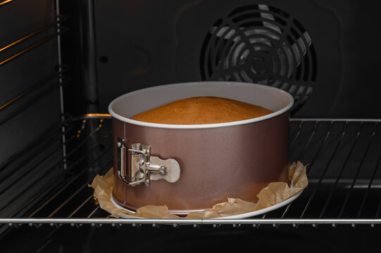 The cake is baked in the oven