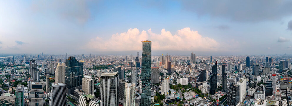 Wide panoramic aerial view of the business district of the urban landscape of the metropolis of Bangkok, Thailand in the early morning