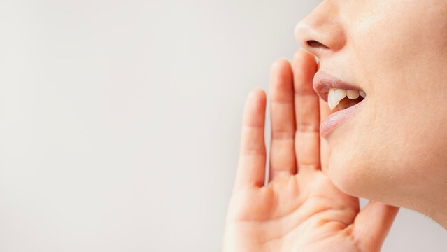The young woman is telling or announcing something