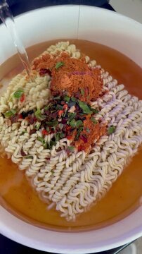Close-up of bubbling hot spicy Korean instant ramen cooking in a pot