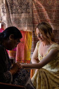 Women getting henna painted on her hand vertical