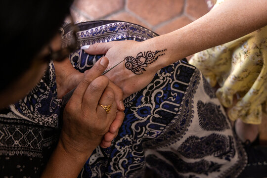Close-up looking down on henna art on woman's hand