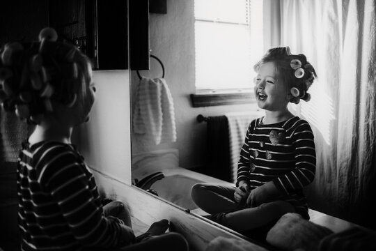 Young Girl looking at herself in the mirror smiling