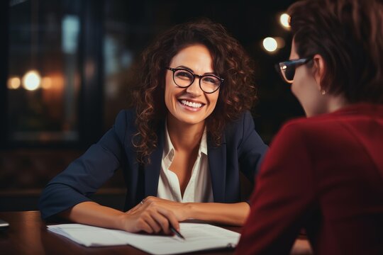 Professional woman discussing a contract with a colleague at the office