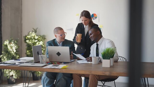Teamwork in office, marketing professionals or program developers communicating. Financial analysis department of big international company, multiethnic coworkers discussing new business project