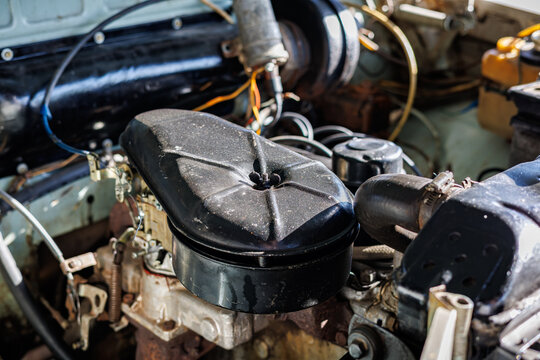 Engine bay of a vintage car, open hood and classic engine details.