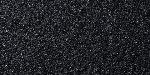 Fototapeta premium Asphalt pavement showing rough texture on dark street