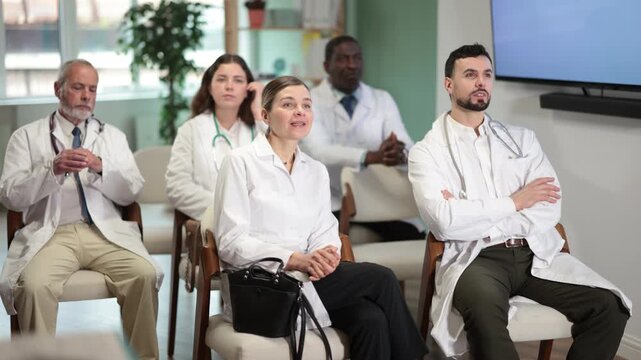 Doctors of different ages and qualifications at the conference, they discuss topical issues. High quality 4k footage
