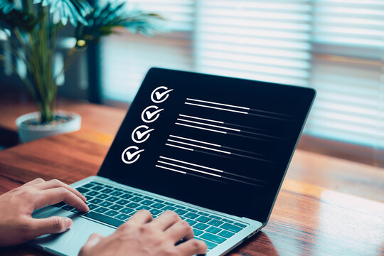 Businessman marking digital checkboxes on a laptop. Check of the document, list survey. task management, verification process, and modern digital workspace. from business, checklist review