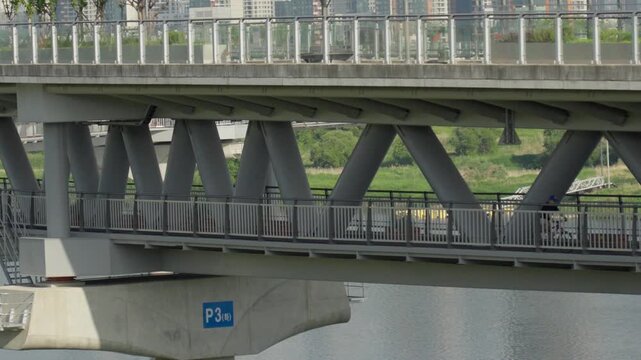 Cyclist Riding a Bicycle on the Lower Deck Bike Path of Geumgang Pedestrian Bridge in Sejong, South Korea