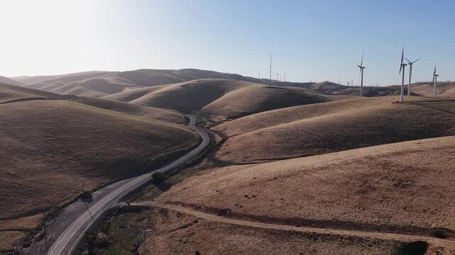 Stunning aerial view of the Altamont Pass wind farm, featuring numerous wind turbines generating renewable energy across the rolling golden hills of Livermore, California during a sunny day