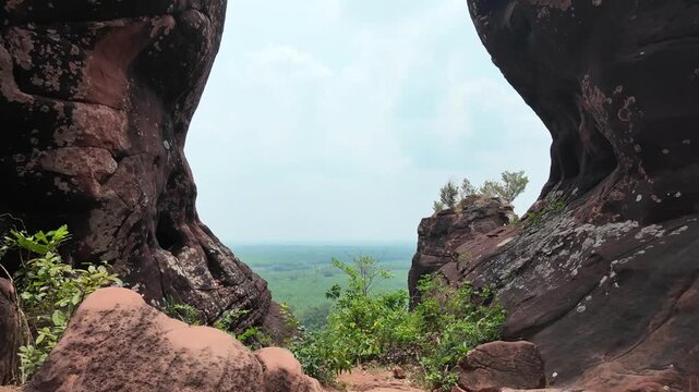 POV walking toward natural rock portal at Three Whale Rock, Bueng Kan, Thailand