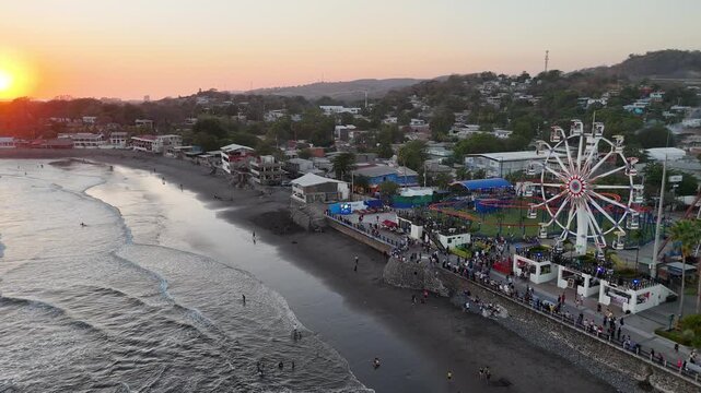 Drone view of Surf City Entertainment Destination with Roller Coaster, Ferris Wheel, and Beach View, El Salvador