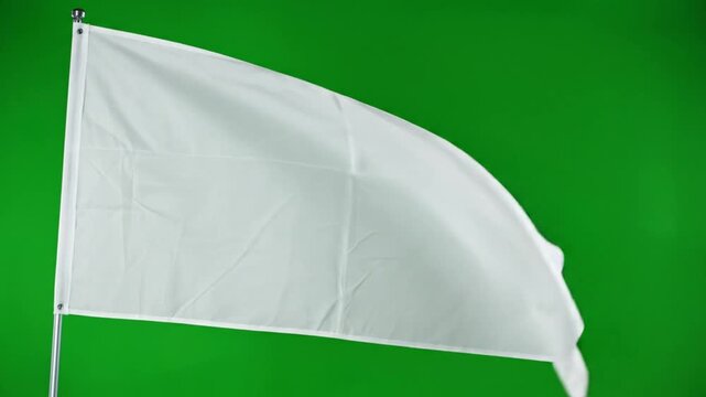 White flag waving on a pole against a solid green background representing surrender or peace