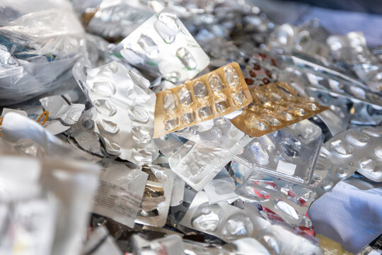 Close up of a large pile of empty aluminum blister packs from pills and medication ready for recycling.