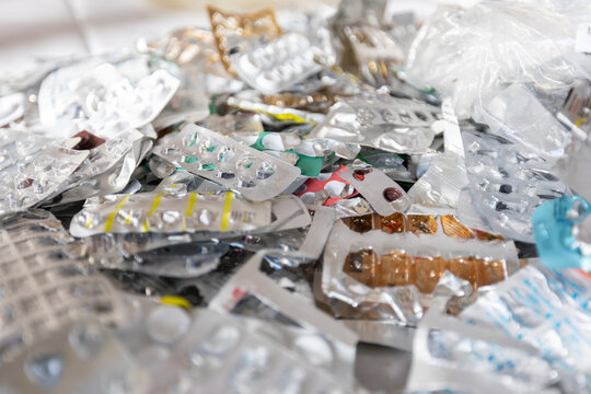 Close up of a large pile of empty aluminum blister packs from pills and medication ready for recycling.