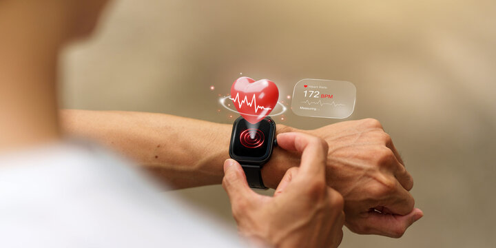 Man checking heart rate on smartwatch with holographic 3D heart and ECG monitor concept