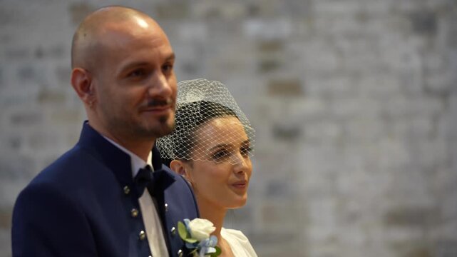 Happy couple exchanging vows in a touching and romantic wedding ceremony surrounded by loved ones