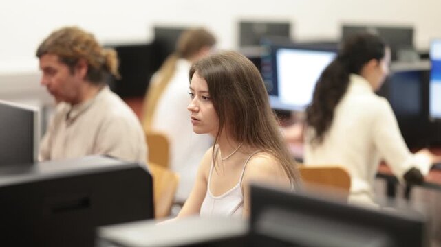 Portrait of young female student studying in university computer class