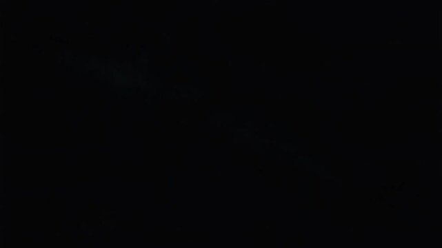 Lightning strike with vibrant glowing plasma energy branching across a dark night sky in this cinematic 4k video motion clip