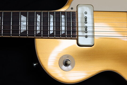 Close-Up of Gold Electric Guitar with P90 Pickup and Toggle Switch