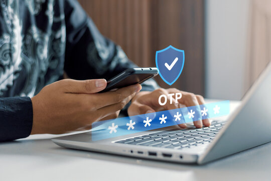 Close up of man verifying identity with OTP code on laptop for secure online transaction, data privacy, cyber fraud prevention, and digital banking concepts