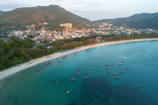 Many people relax on the white sand of Kata Beach in Phuket, Thailand