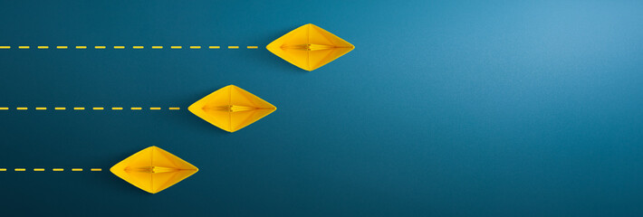 Yellow paper ship on blue background, Business competition concept. copy space
