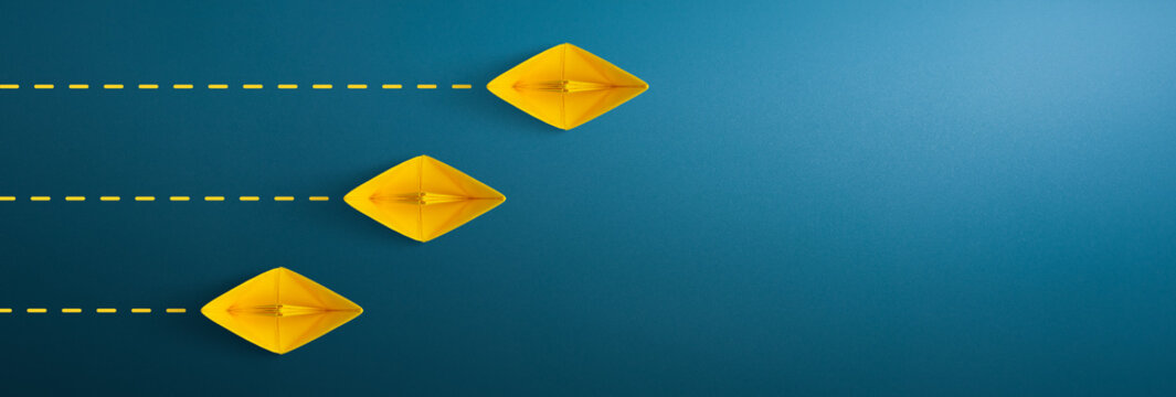 Yellow paper ship on blue background, Business competition concept. copy space