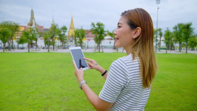 Happy Solo Female Traveler Exploring Ancient Temple Ruins in Thailand during Summer Vacation