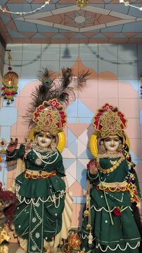 Close-up of Radha Krishna Idols and Peacock Feather Decoration