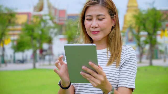Happy Solo Female Traveler Exploring Ancient Temple Ruins in Thailand during Summer Vacation