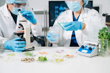 Fototapeta premium Female nutritionist in lab coat analyzing food and writing in notebook. Healthy eating, organic testing, and nutrition science