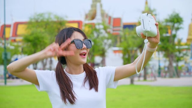 Happy Solo Female Traveler Exploring Ancient Temple Ruins in Thailand during Summer Vacation
