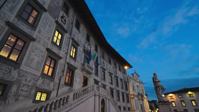 Piazza dei Cavalieri at night in Pisa with historic architecture and lighting