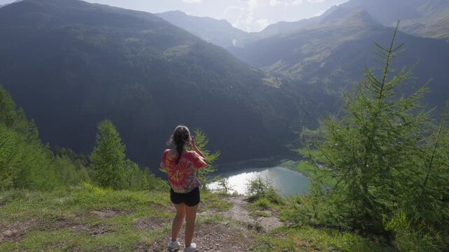 Young European woman viewpoint mountain overlooking Spluga valley Italy Lago Di Isola