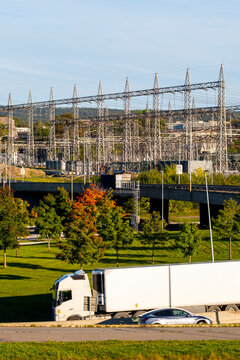Oslo Norway utility structures give power grid infrastructure a hard industrial scale beside a green roadside and urban transport corridor