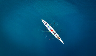 Aerial View of Rowing Team Training on Deep Blue Water © cn.ycl