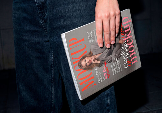 Person holding blank magazine or booklet mockup
