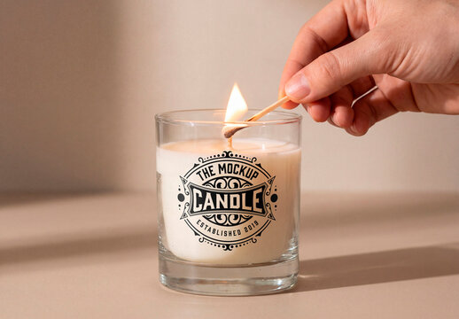 Glass candle mockup being lit by hand