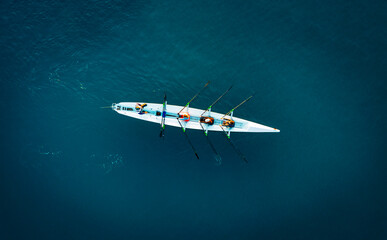 Aerial View of Rowing Team Training on Deep Blue Water © cn.ycl