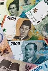 Indonesian rupiah money banknotes pile on table. Indonesia bills of IDR currency close up © Larysa