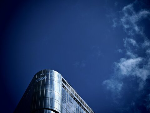 Modern Glass Skyscraper Against a Deep Blue Sky