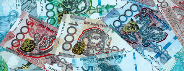 Fototapeta premium Kazakhstani tenge money banknotes pile on table. Kazakhstan bills of KZT currency close up